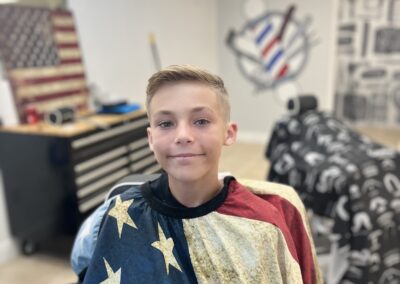 boy with american flag cover and fresh haircut